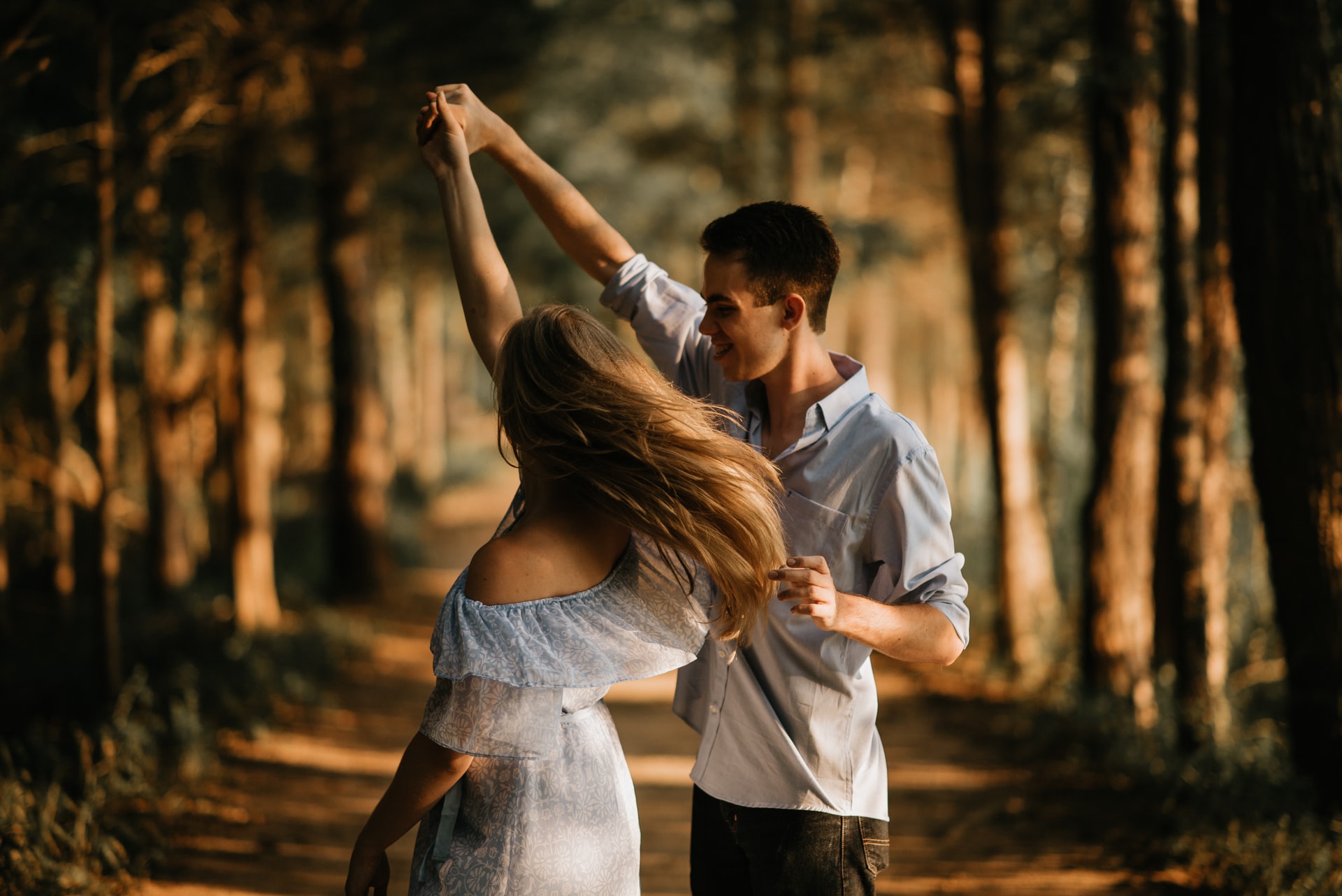 couple dancing in warm woods, captured moment photography