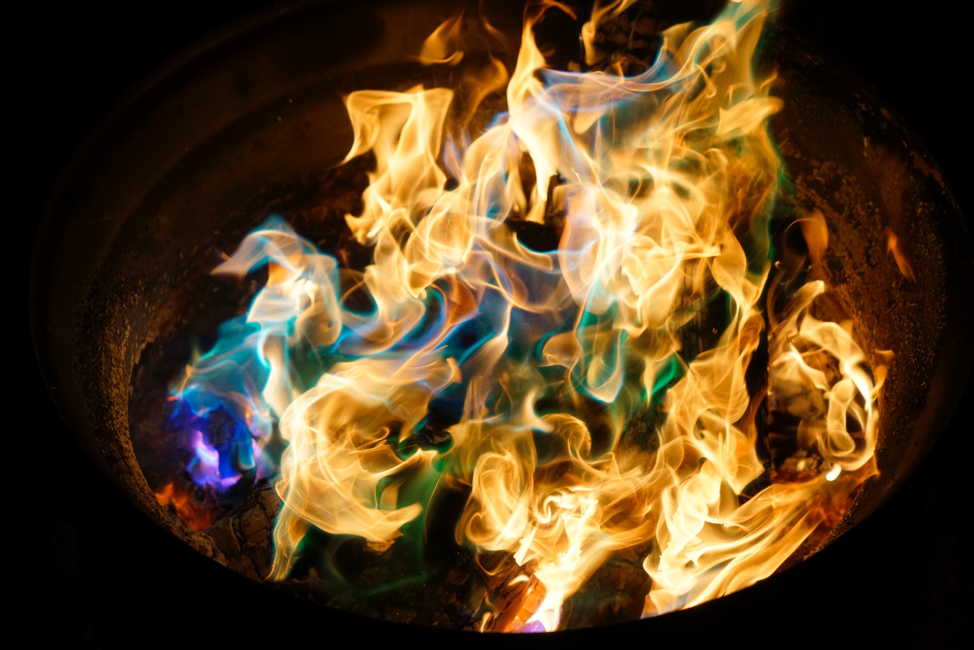 Photo of a fire with blues and greens woven into the flames
