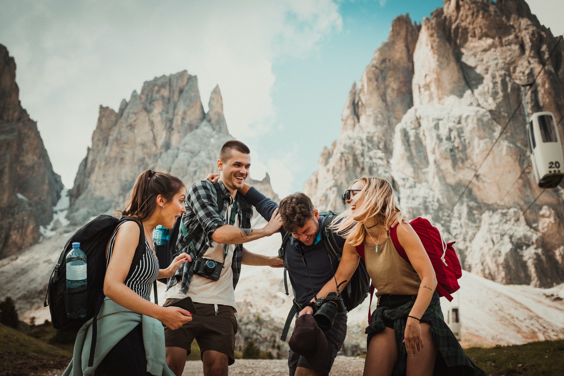 A group of photographers laughing with each other against a mountainous backdrop