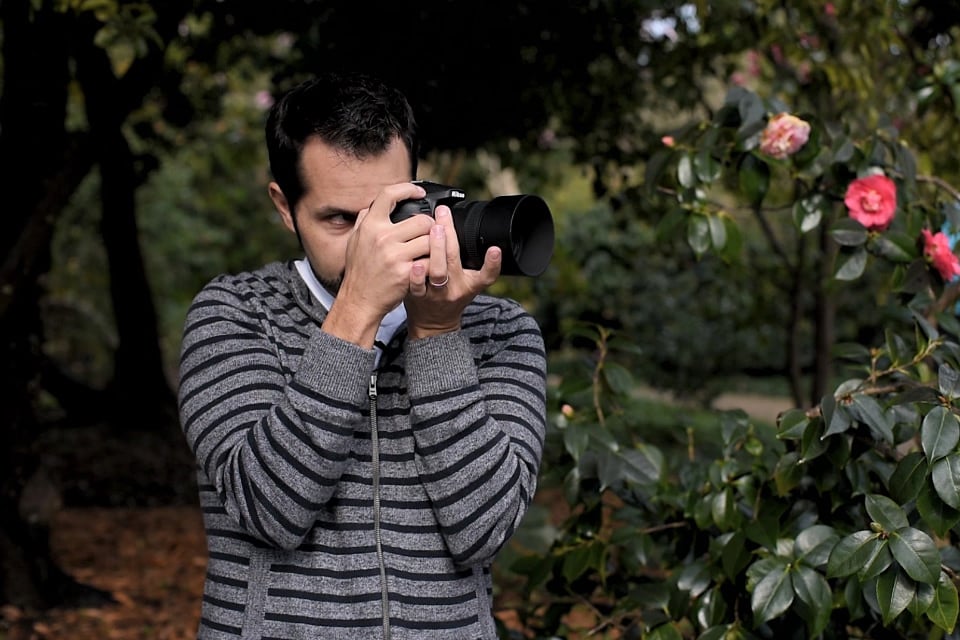 photographer in photography stance for steady hands, solving blurry photos